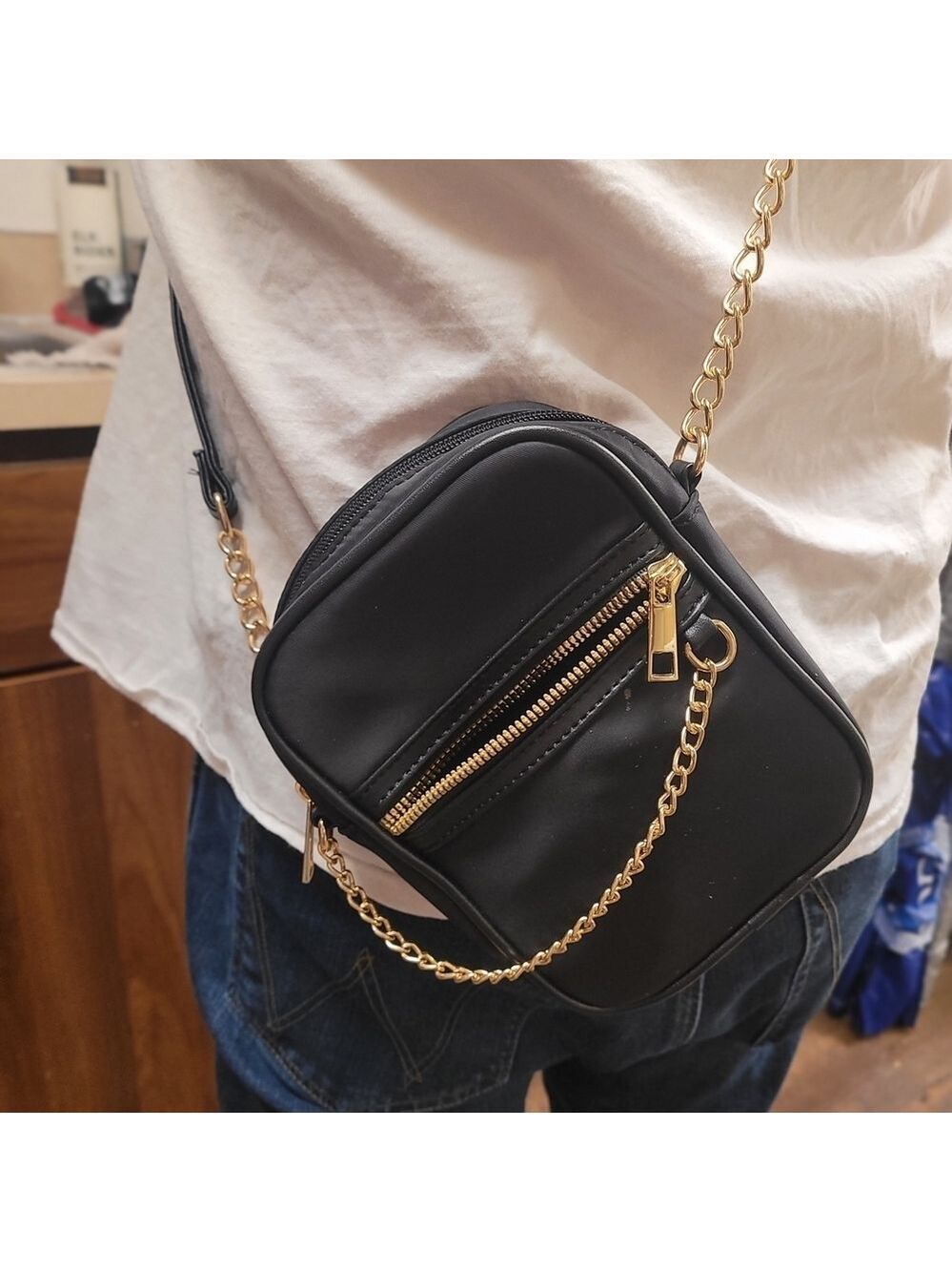 Elegant Black Crossbody Bag with Gold Accents